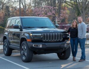 2024 Jeep Black Man and Woman beside after repairs at Lindsay Collision Center 2024 Jeep Black customers standing next to it at Lindsay Collision Center, Manassas