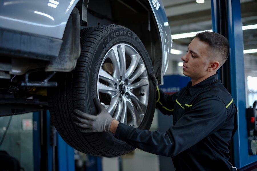 auto-body-technician-mounting-balancing-a-wheel-Lindsay-Collision-Center