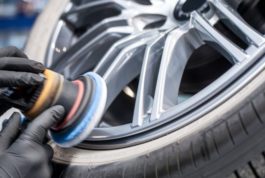 auto-body-technician-repairing-scratches-on-an-alloy-wheel-Lindsay-Collision-Center